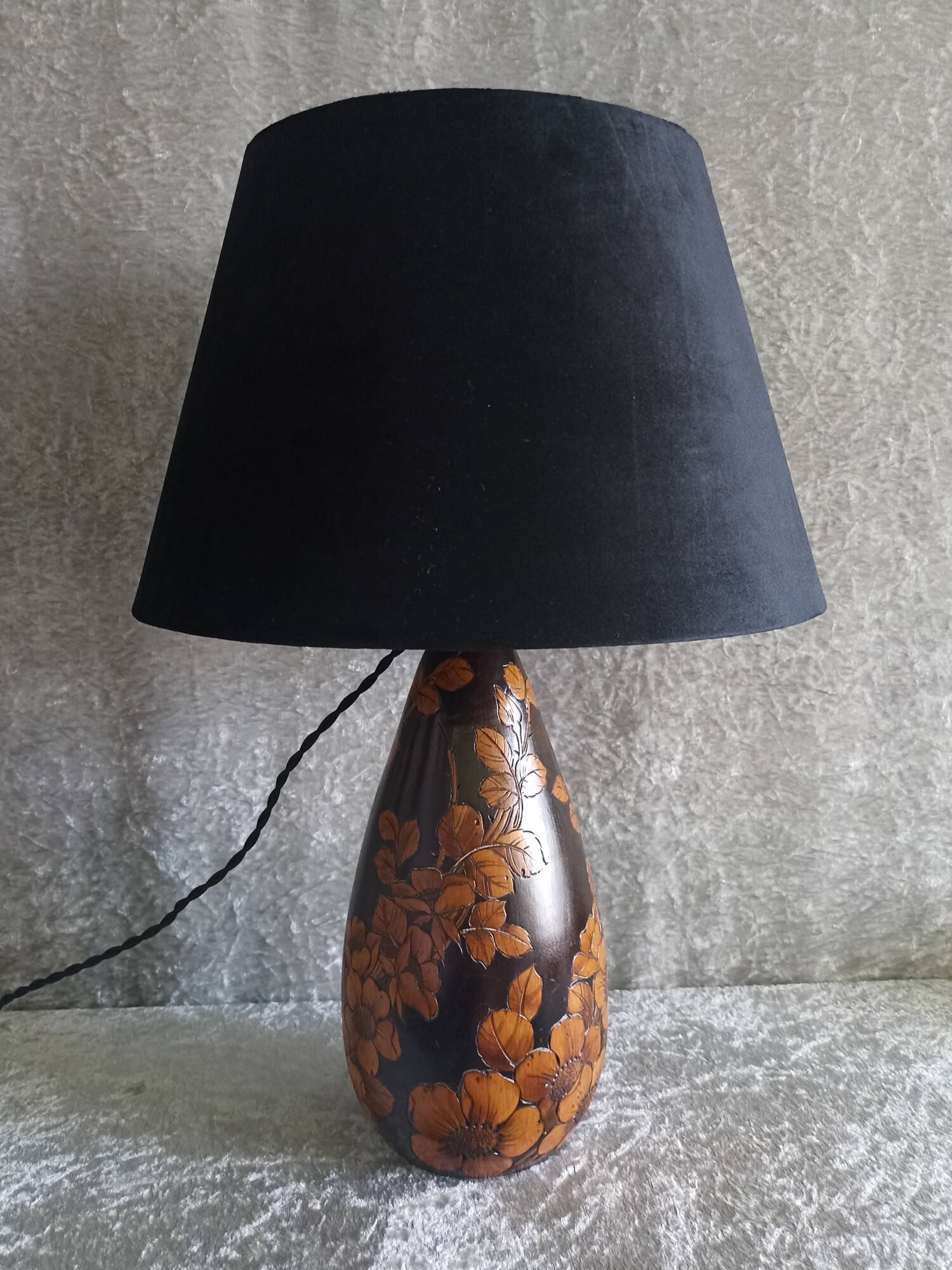 Carved wooden lamp with floral motif