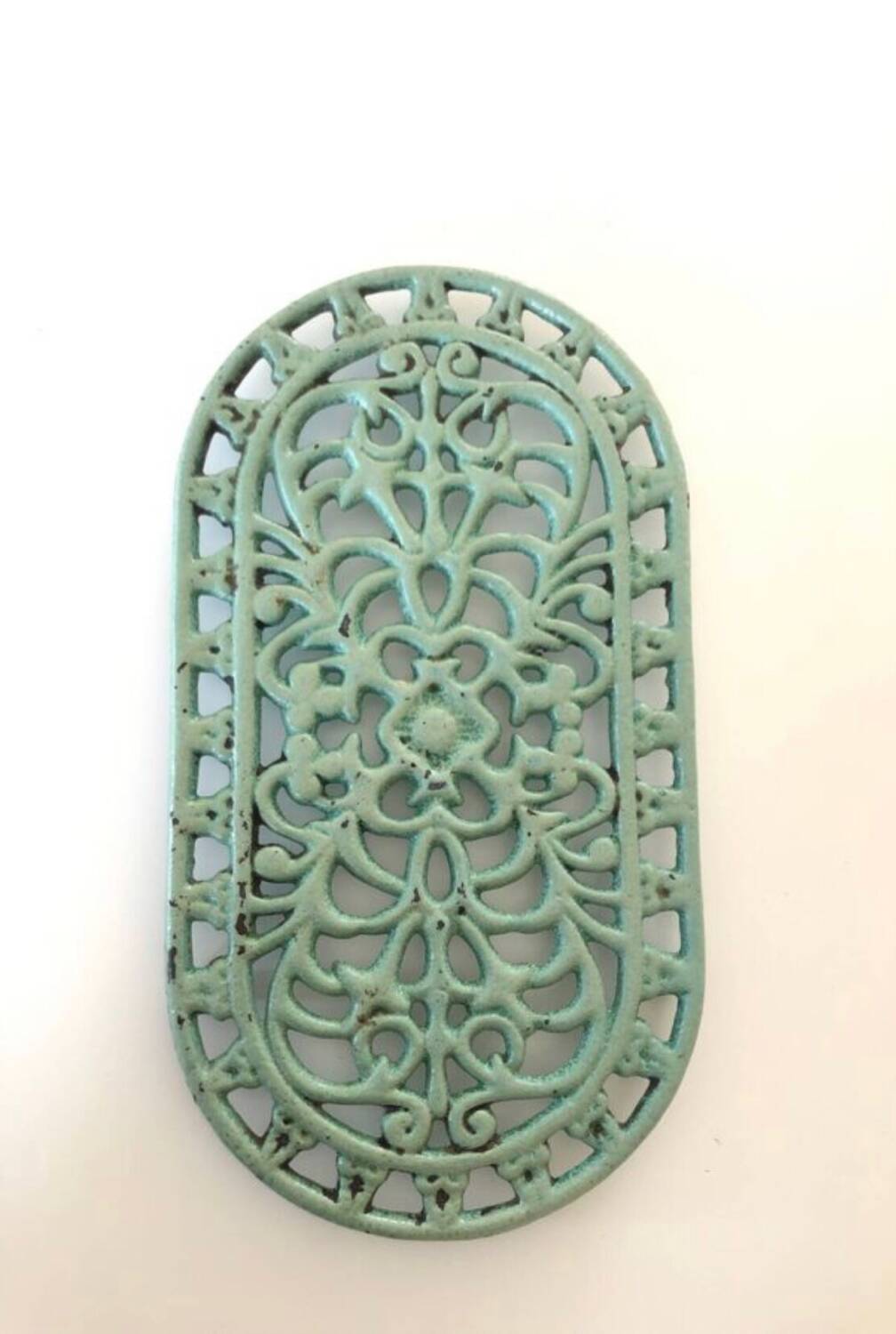 Old oval trivet in green enameled cast iron