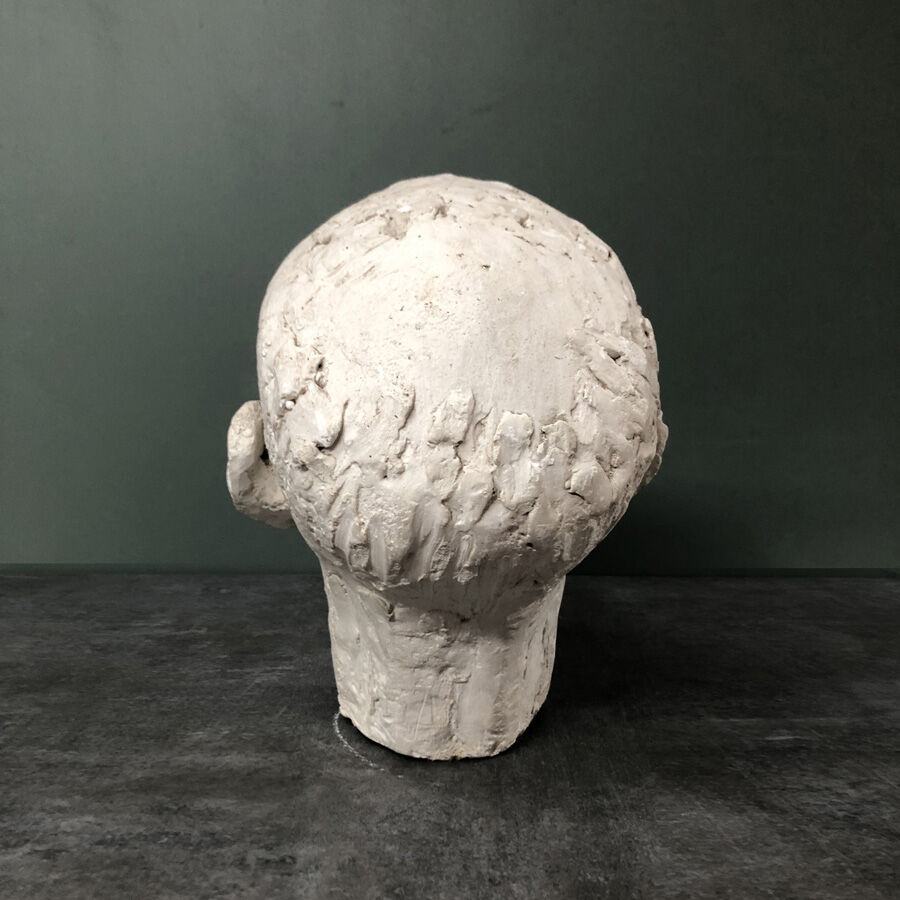 Head of a man with a plaster mustache
