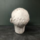 Head of a man with a plaster mustache