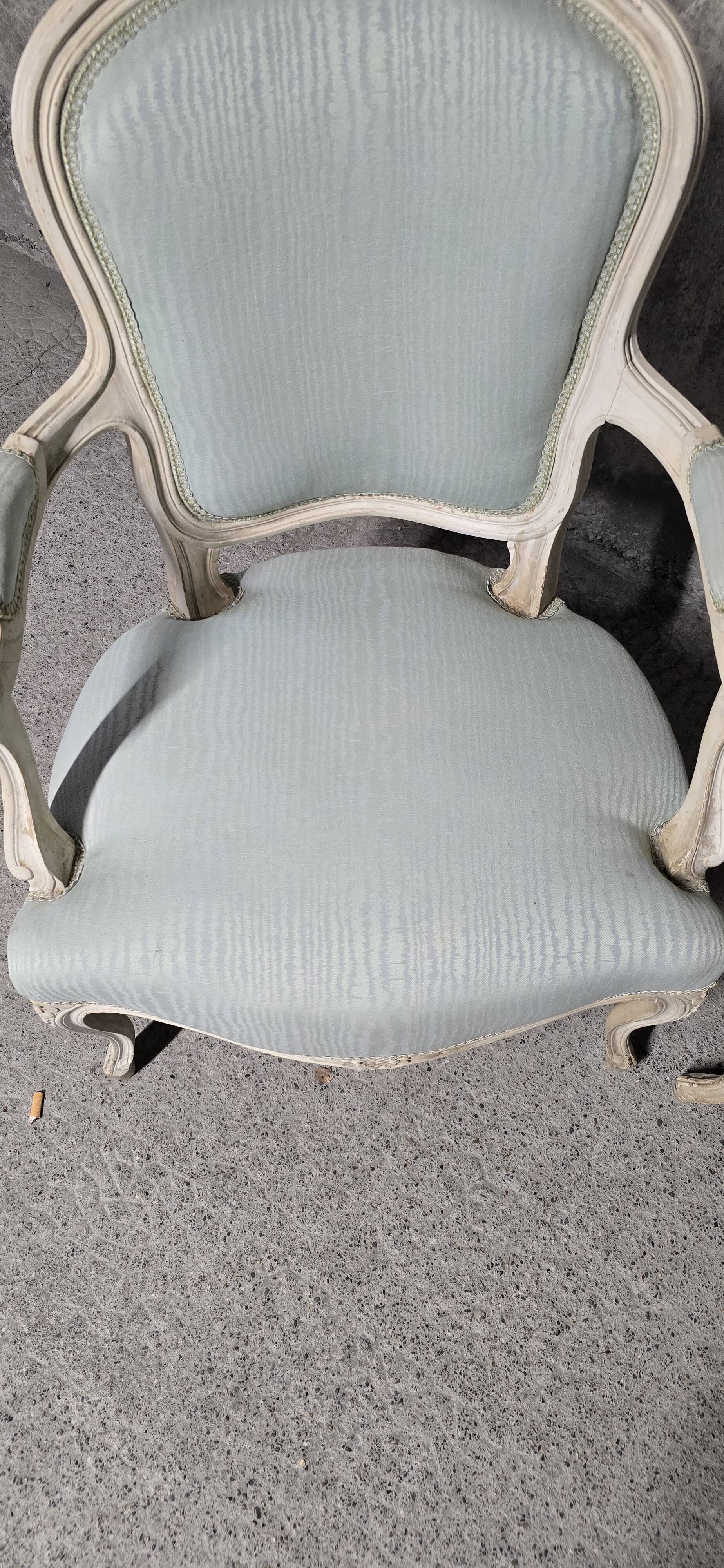 Pair of Louis XV style armchairs in patinated wood, light blue fabric.