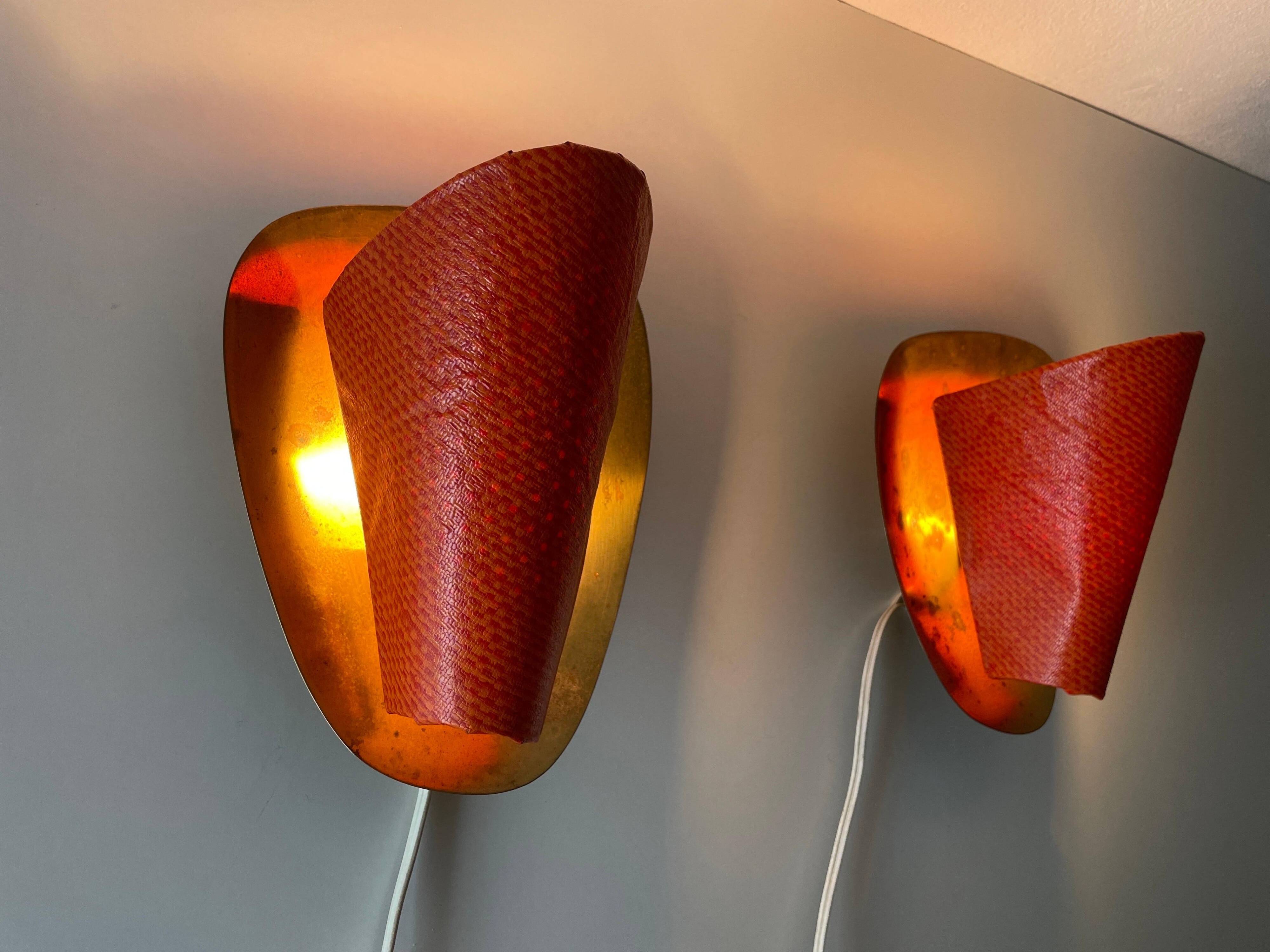 Pair of orange plexiglass and curved brass wall lights, 1950s, Germany