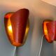 Pair of orange plexiglass and curved brass wall lights, 1950s, Germany
