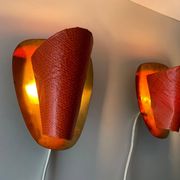 Pair of orange plexiglass and curved brass wall lights, 1950s, Germany