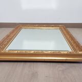 Mirror in gilded stucco wood and beveled glass