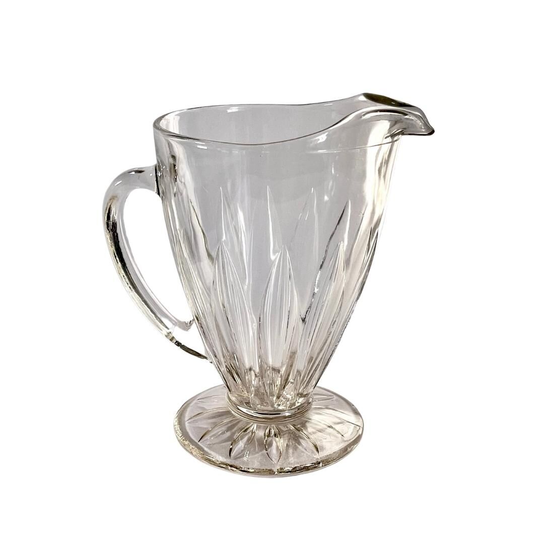 Glass pitcher on base