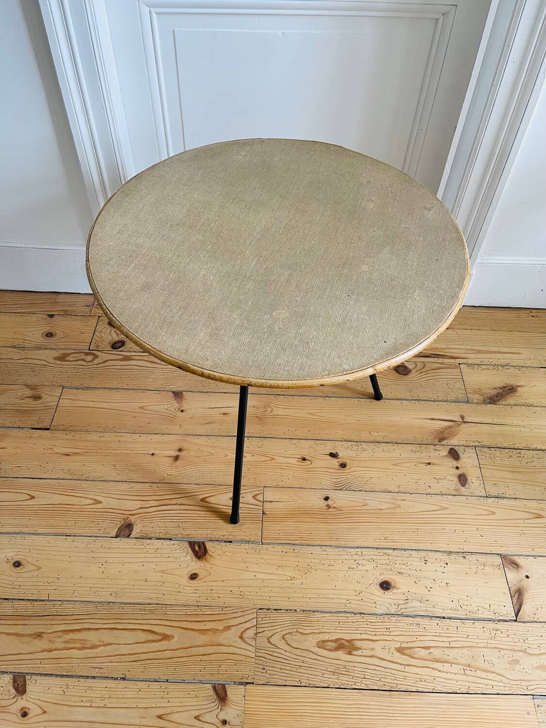 Tripod coffee table with a straw covering.