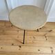Tripod coffee table with a straw covering.