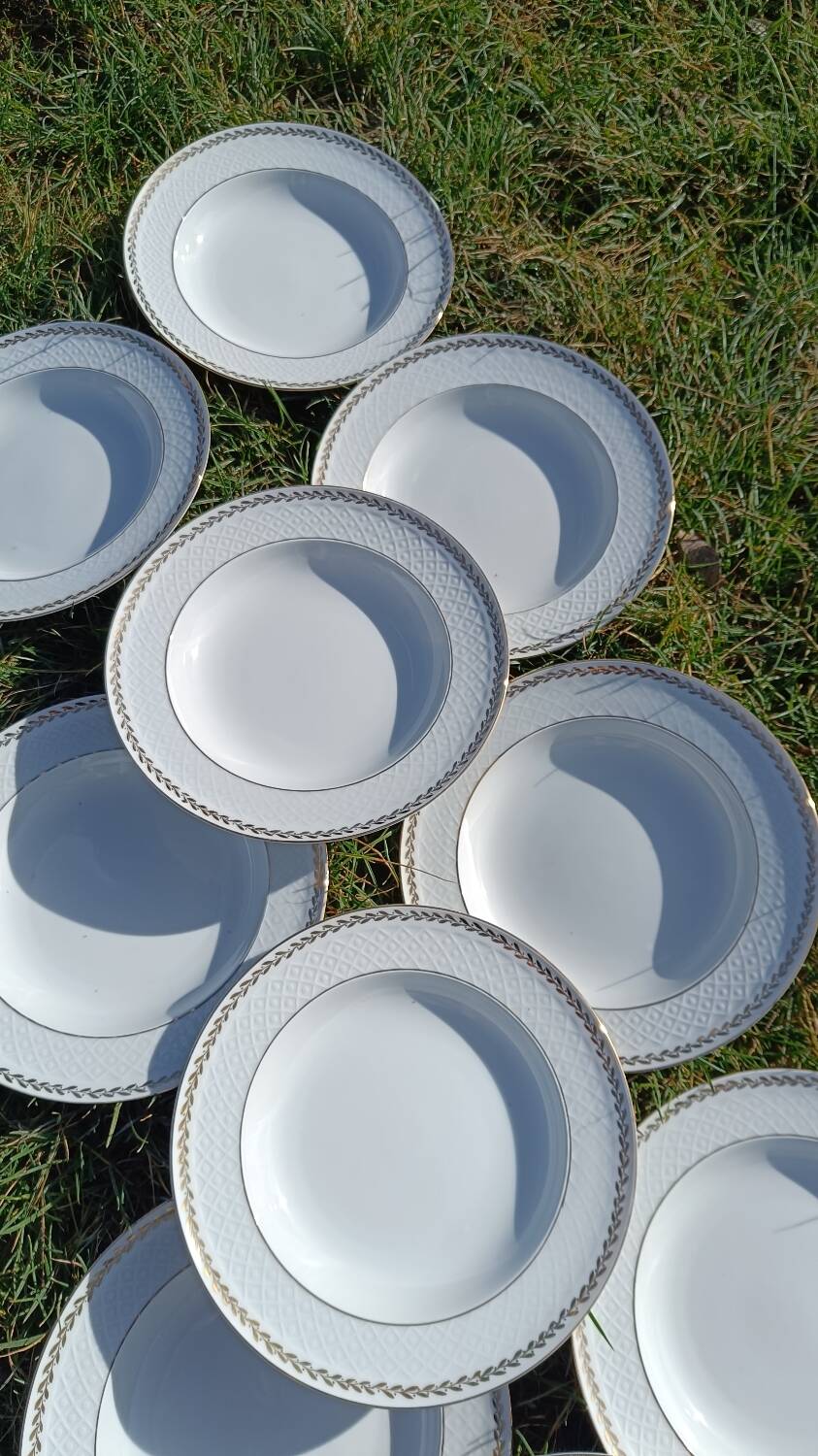Twelve white porcelain plates