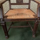 Antique armchair in carved wood and straw seat