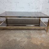 1970s coffee table in brass with a double smoked glass top.