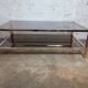 1970s coffee table in brass with a double smoked glass top.
