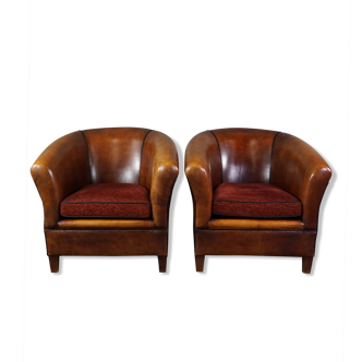 Set of 2 sheepskin club chairs with black piping and fabric cushions