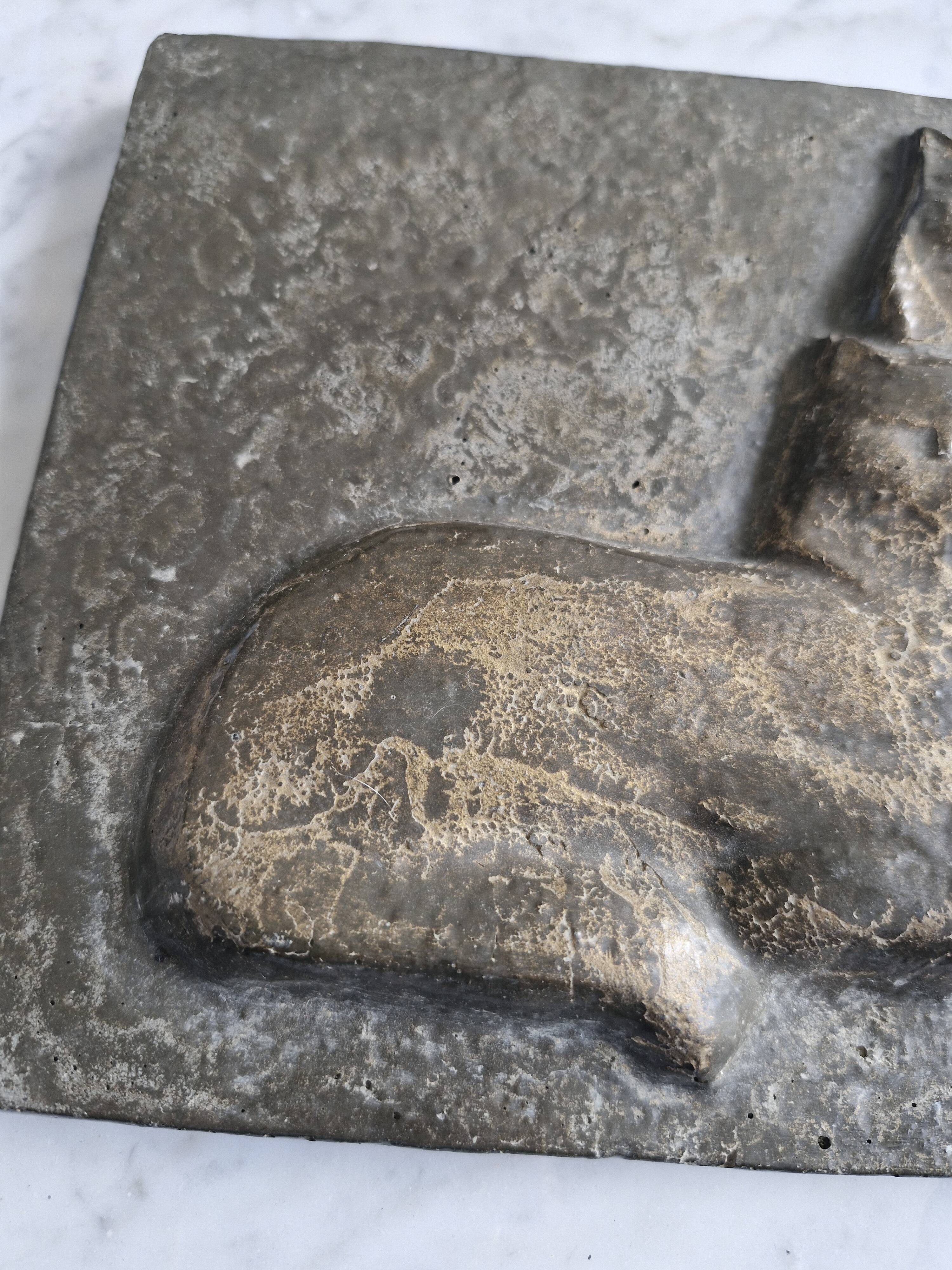 Bas-relief plaque of a rabbit in brown patina, seated cat