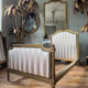 Pair of late 19th-century gilded wooden beds in Louis XVI style.