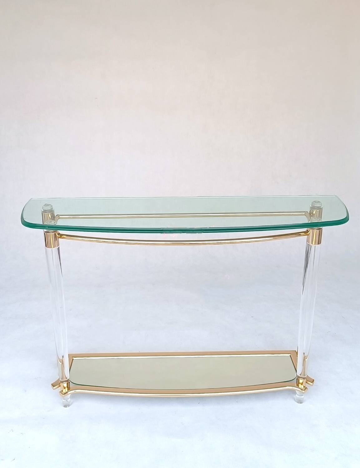 Hollywood Regency console table in lucite, glass and gold metal. 1980s