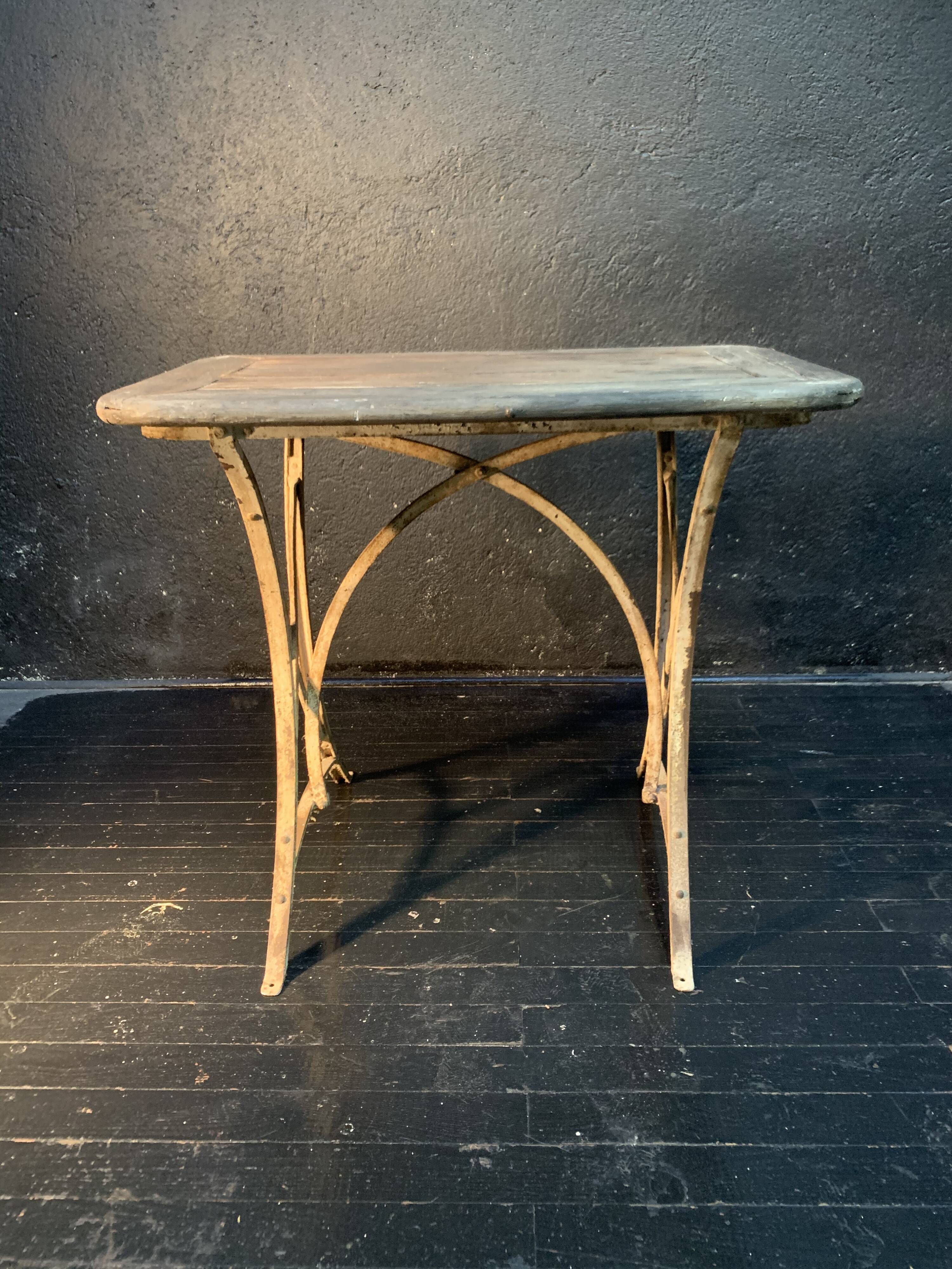 Ancient wrought iron and wood garden table