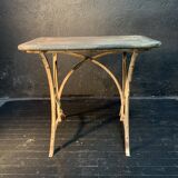 Ancient wrought iron and wood garden table