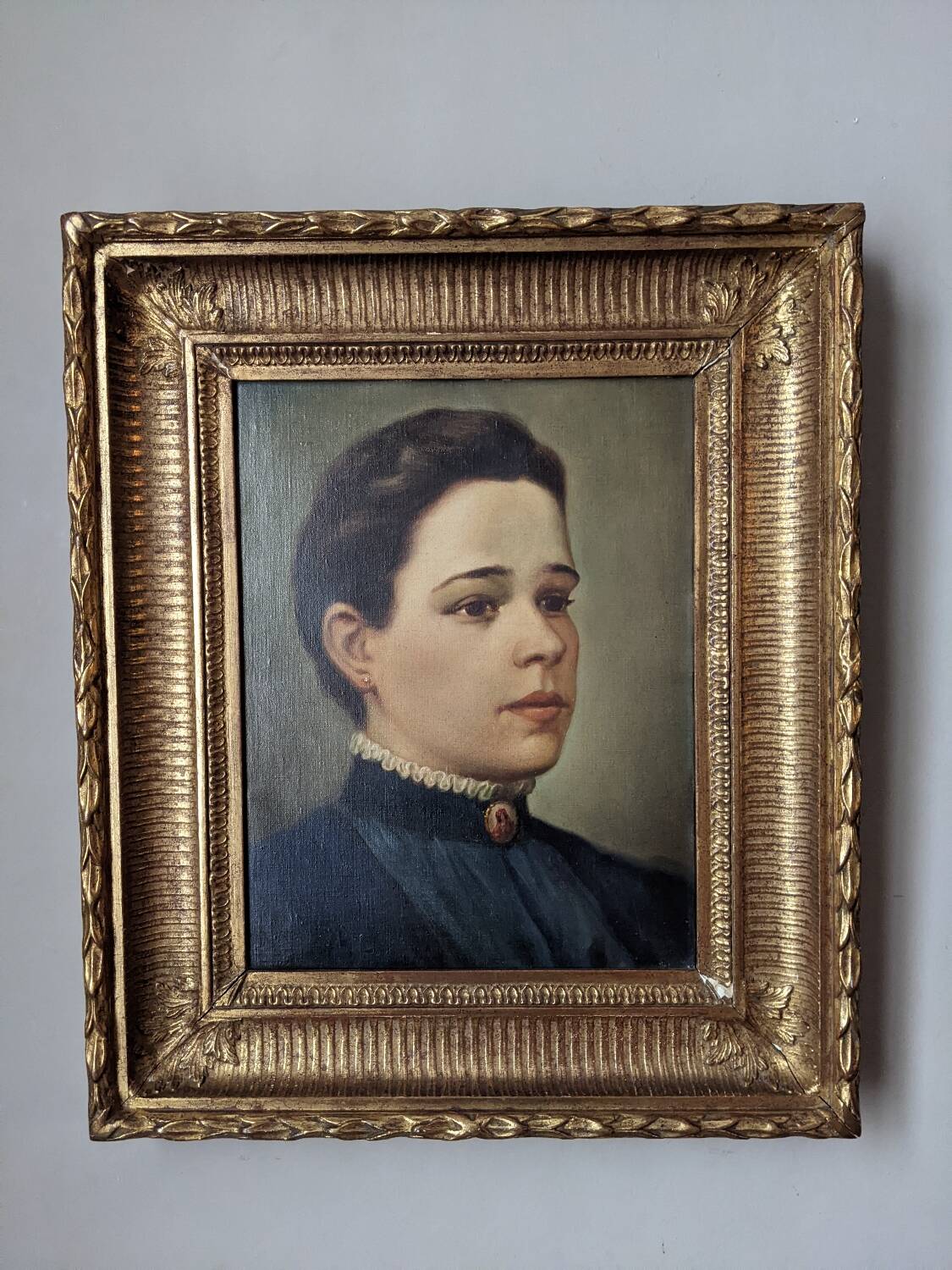 Oil on canvas portrait in an antique gilded wooden frame.