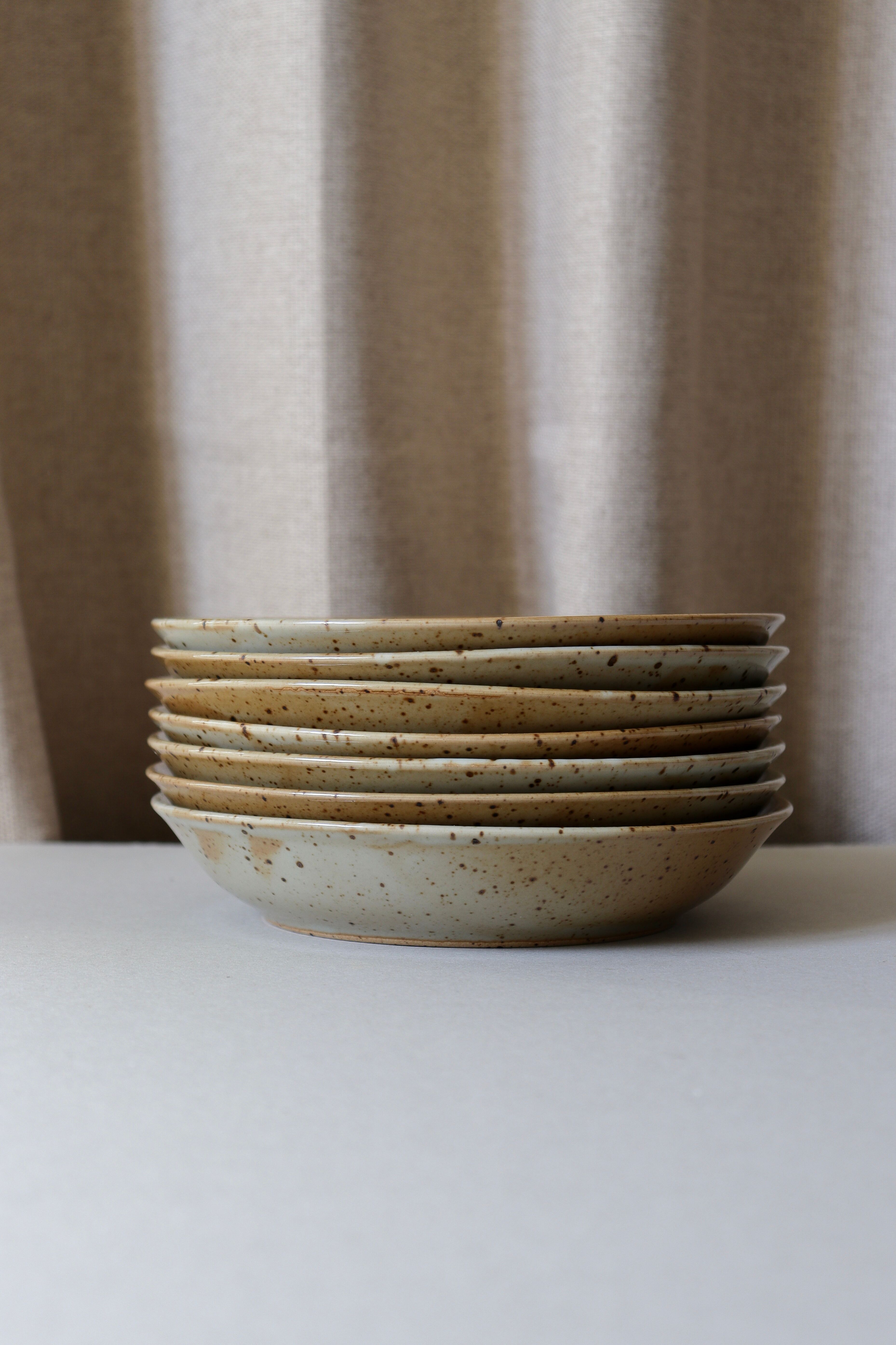 7 speckled stoneware plates