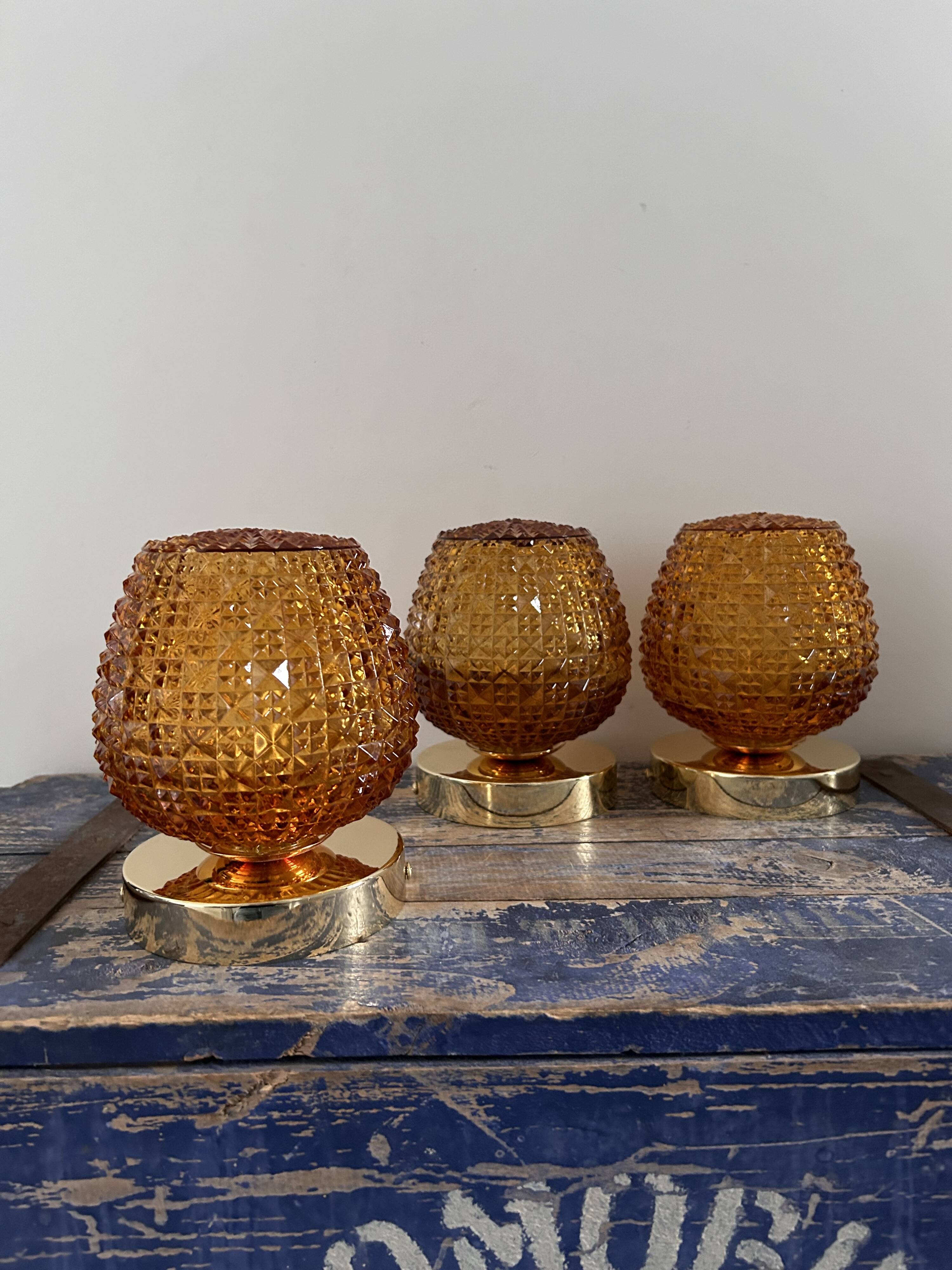 Set of three vintage wall or ceiling lights in amber chiseled glass