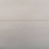White flat sheet with AG monogram