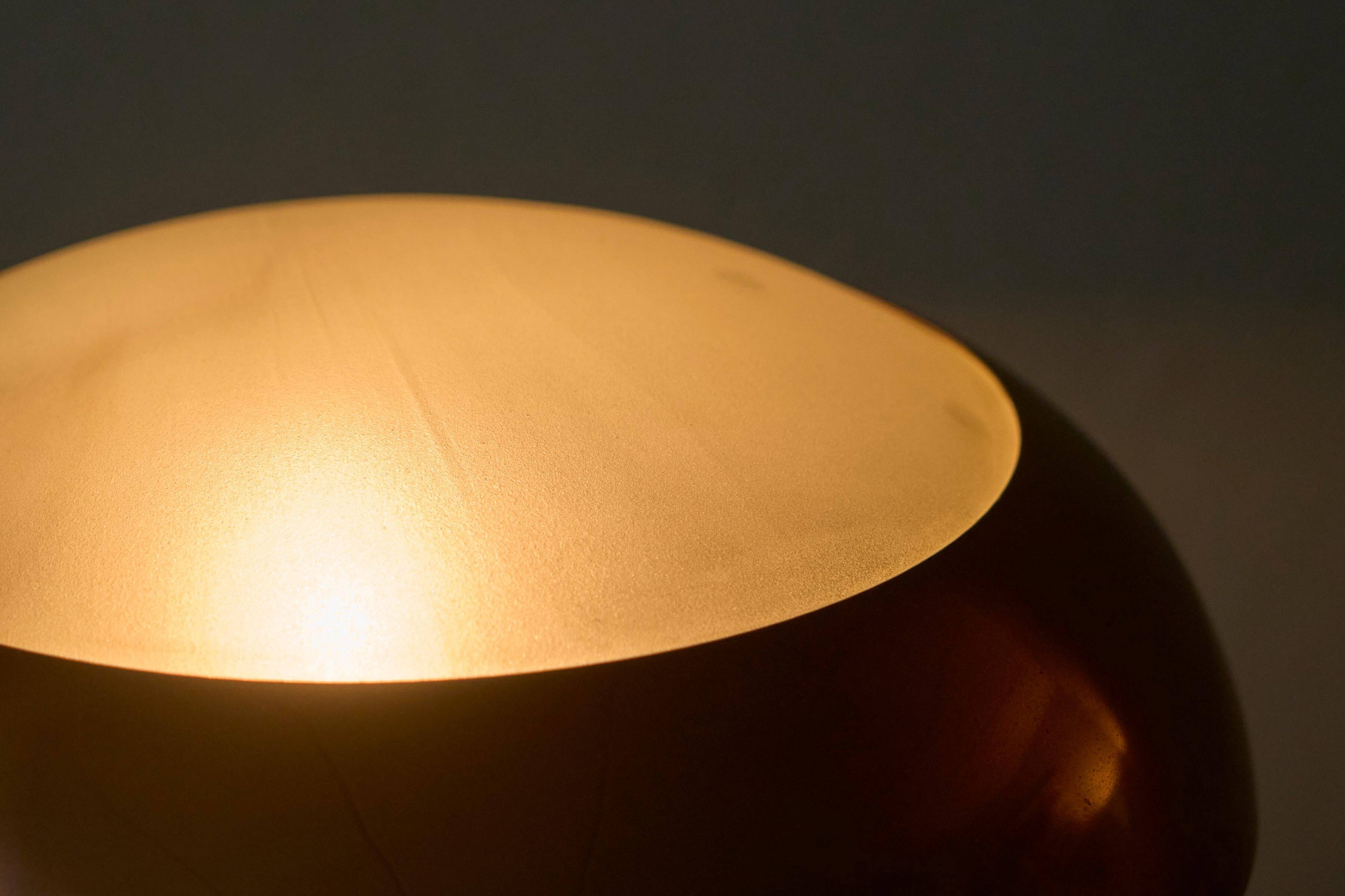 Art Deco table lamp in patinated copper, brass, and satin glass from the 1950s.