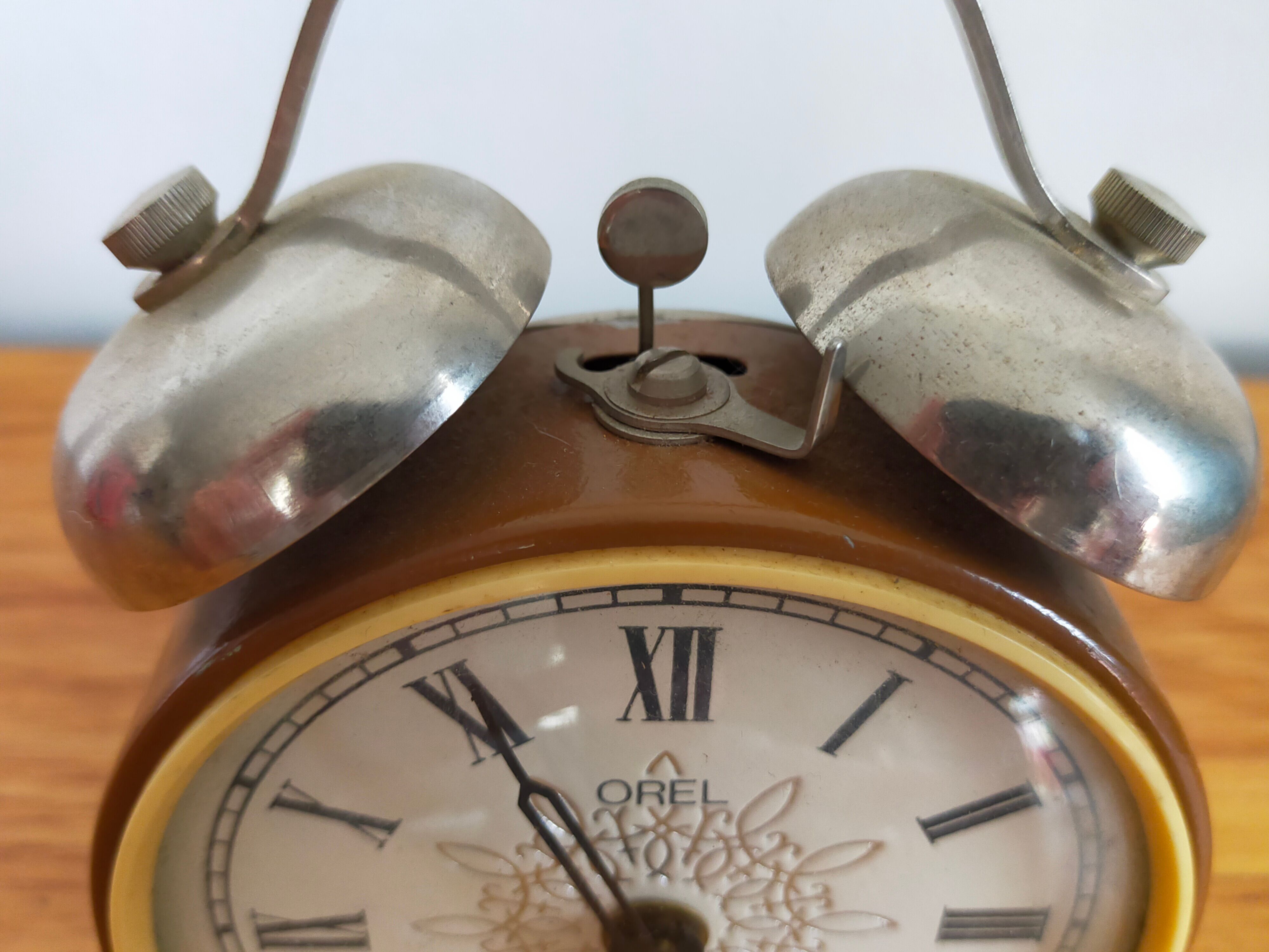 Vintage brown and silver mechanical alarm clock
