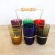 Set of 6 coloured glasses in their brass holder, basket