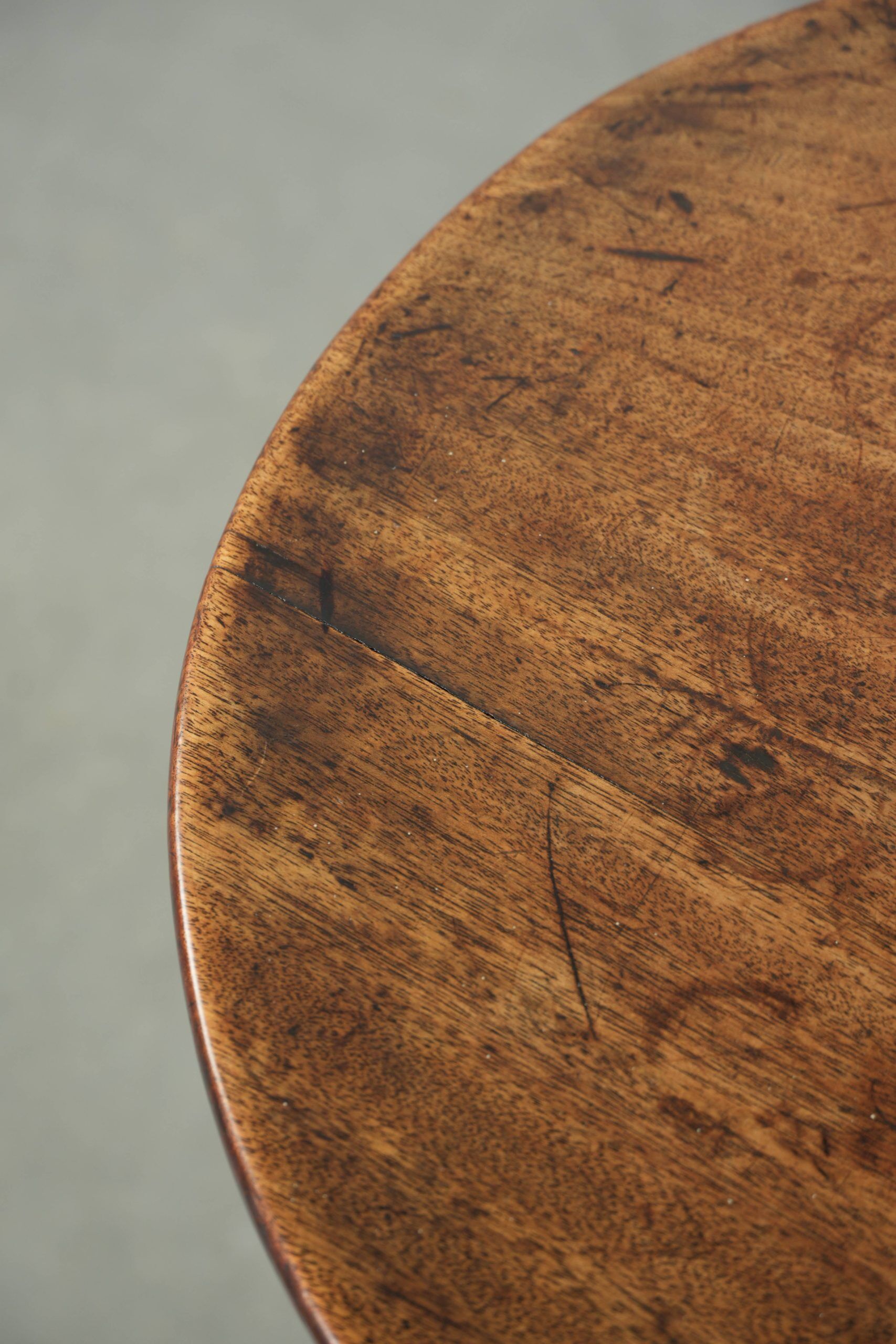 Round antique side/wine table from the late 18th century with a subtle foot