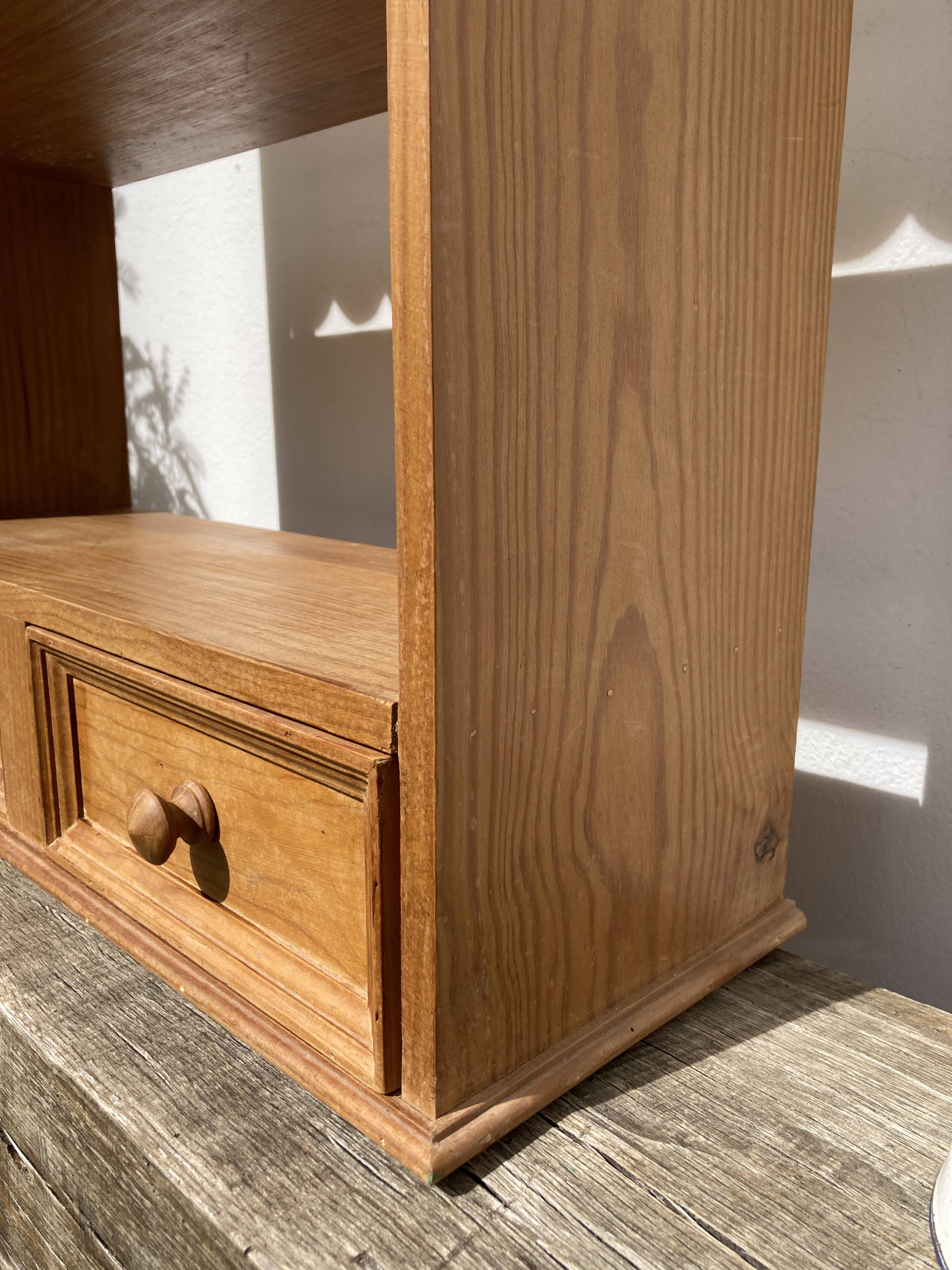Wall shelf in raw wood with drawers and openwork hearts