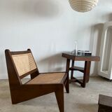 Reclined armchair in canned teak in natural wood