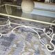 Wrought iron table by Roche Bobois, with a glass top.
