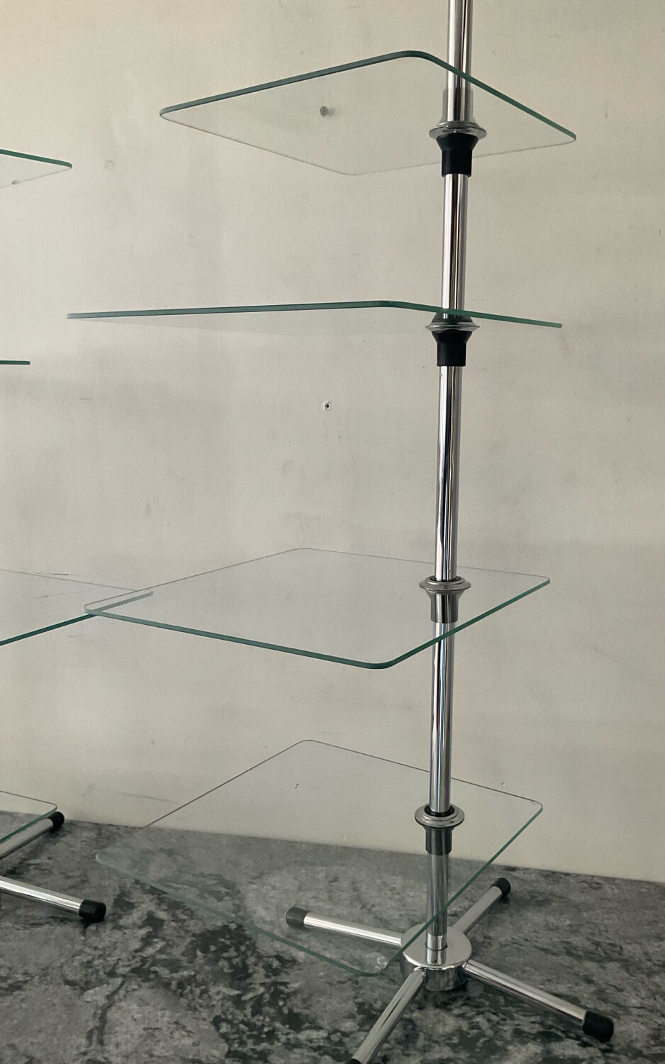 A pair of vintage side tables in glass and chrome metal.