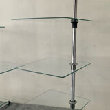 A pair of vintage side tables in glass and chrome metal.