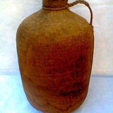 Demijohn dressed in burlap and padded cork