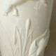 Thick white porcelain vase with relief decoration of a flying duck.