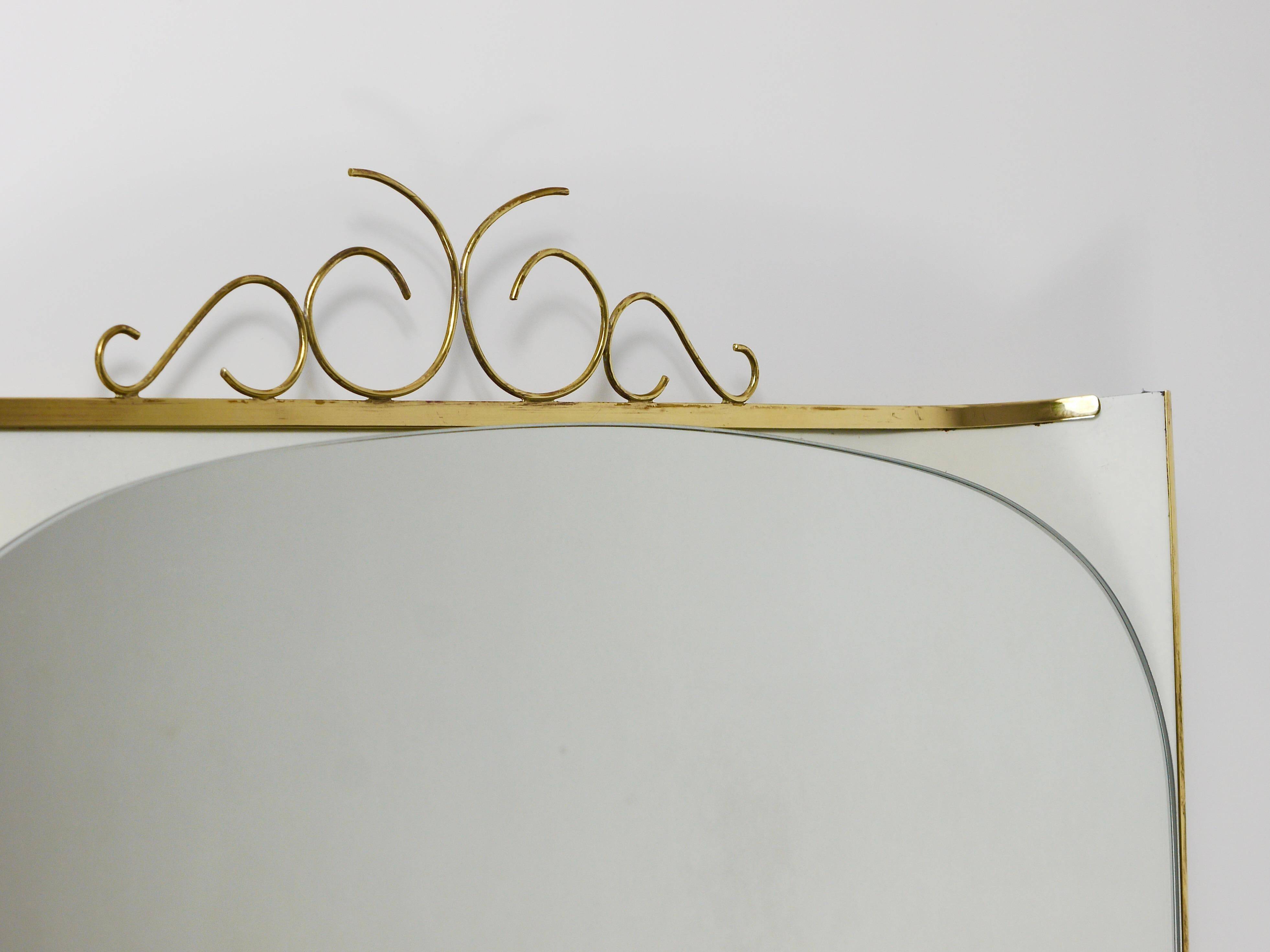 Mid-century illuminated wall mirror by Ernest Igl with brass crown, by Hillebrand.