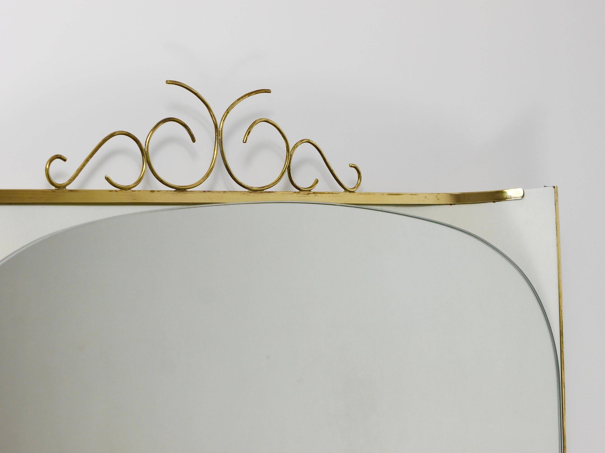Mid-century illuminated wall mirror by Ernest Igl with brass crown, by Hillebrand.