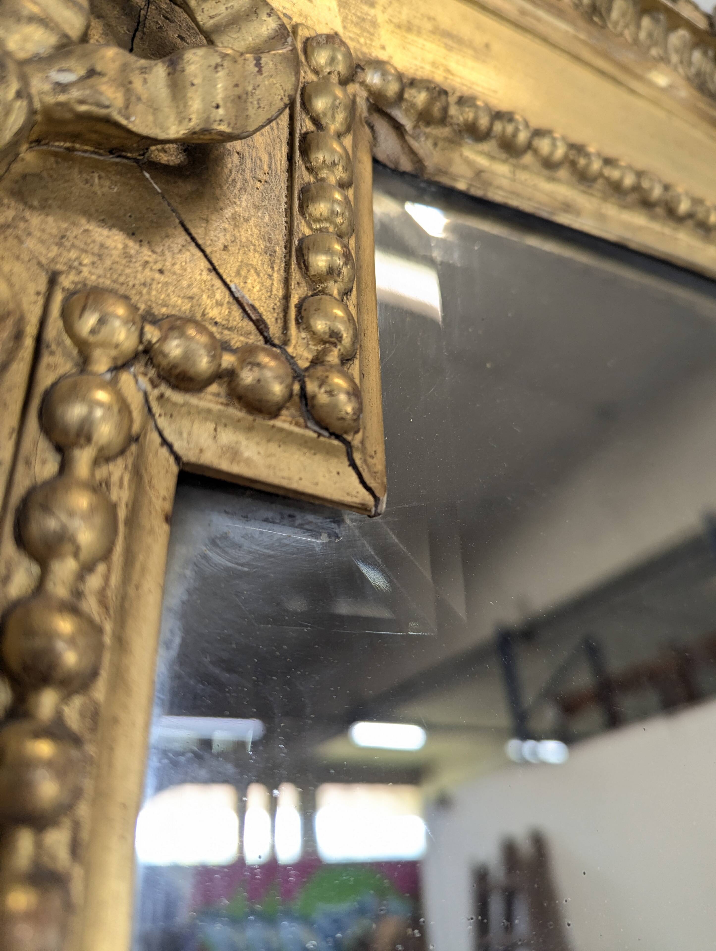 Large gilded wooden mirror in Louis XVI style from the late 19th century.