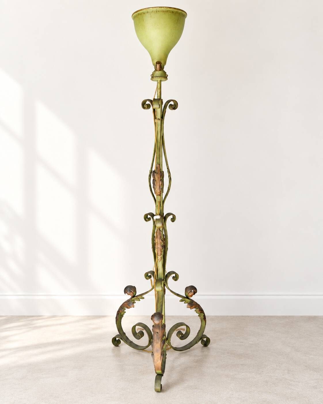 Antique green-painted iron floor lamp with a floral design.