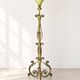 Antique green-painted iron floor lamp with a floral design.
