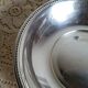 Shallow round metal plate with pearl row decoration.