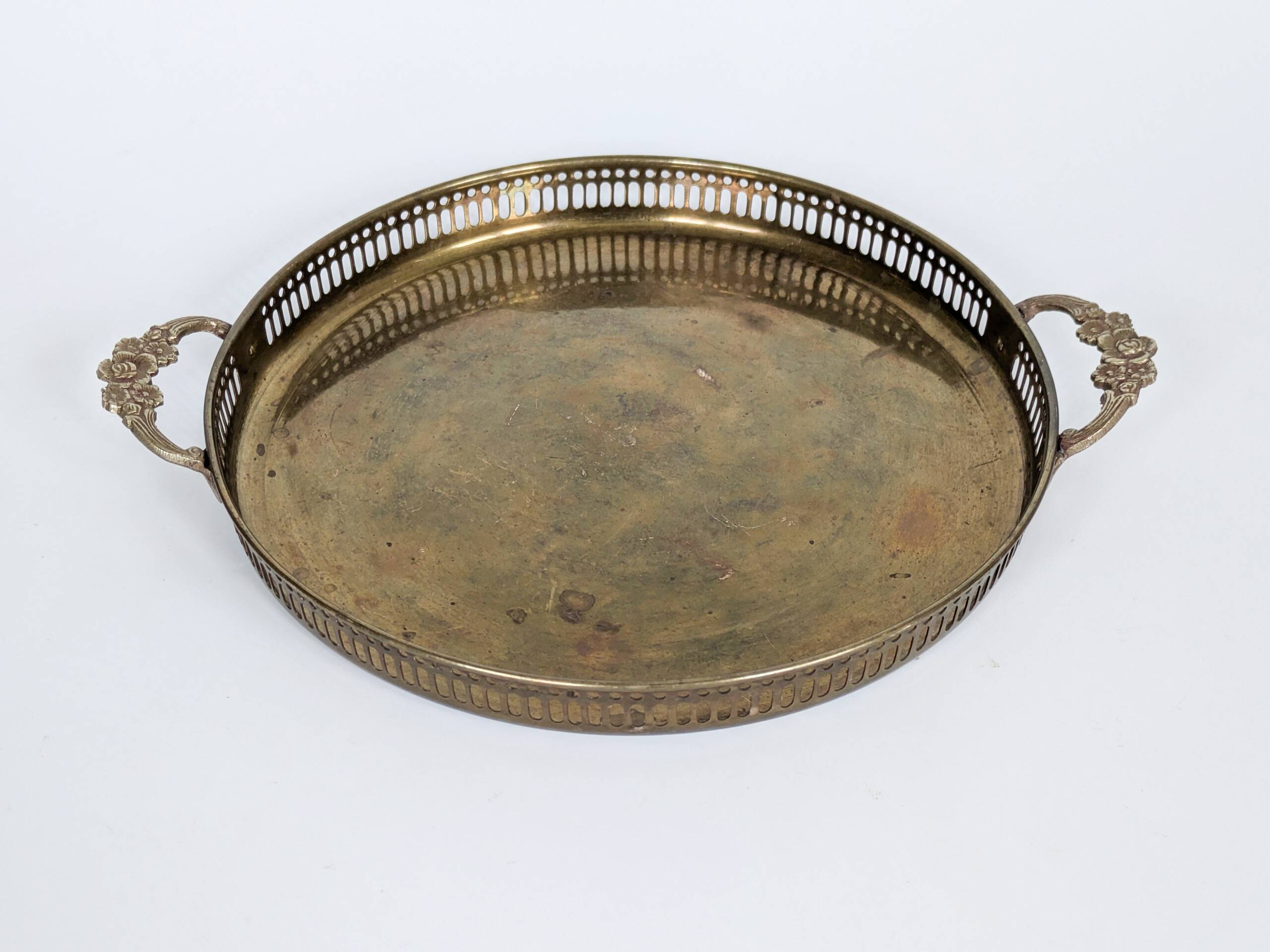 Vintage decorative brass tray, pierced edge and floral handles.