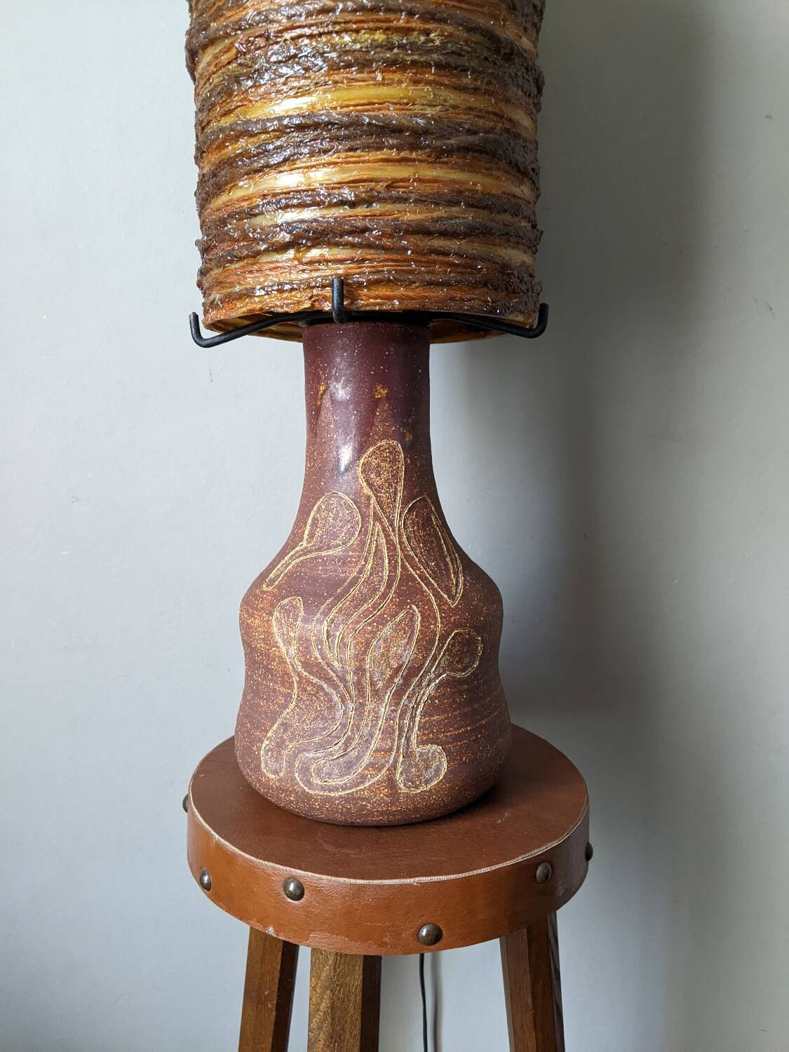 Table lamp with terracotta base and resin shade.