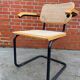 Cesca model chair designed by Marcel Breuer with black-framed armrests