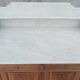 Antique walnut and white marble bathroom cabinet