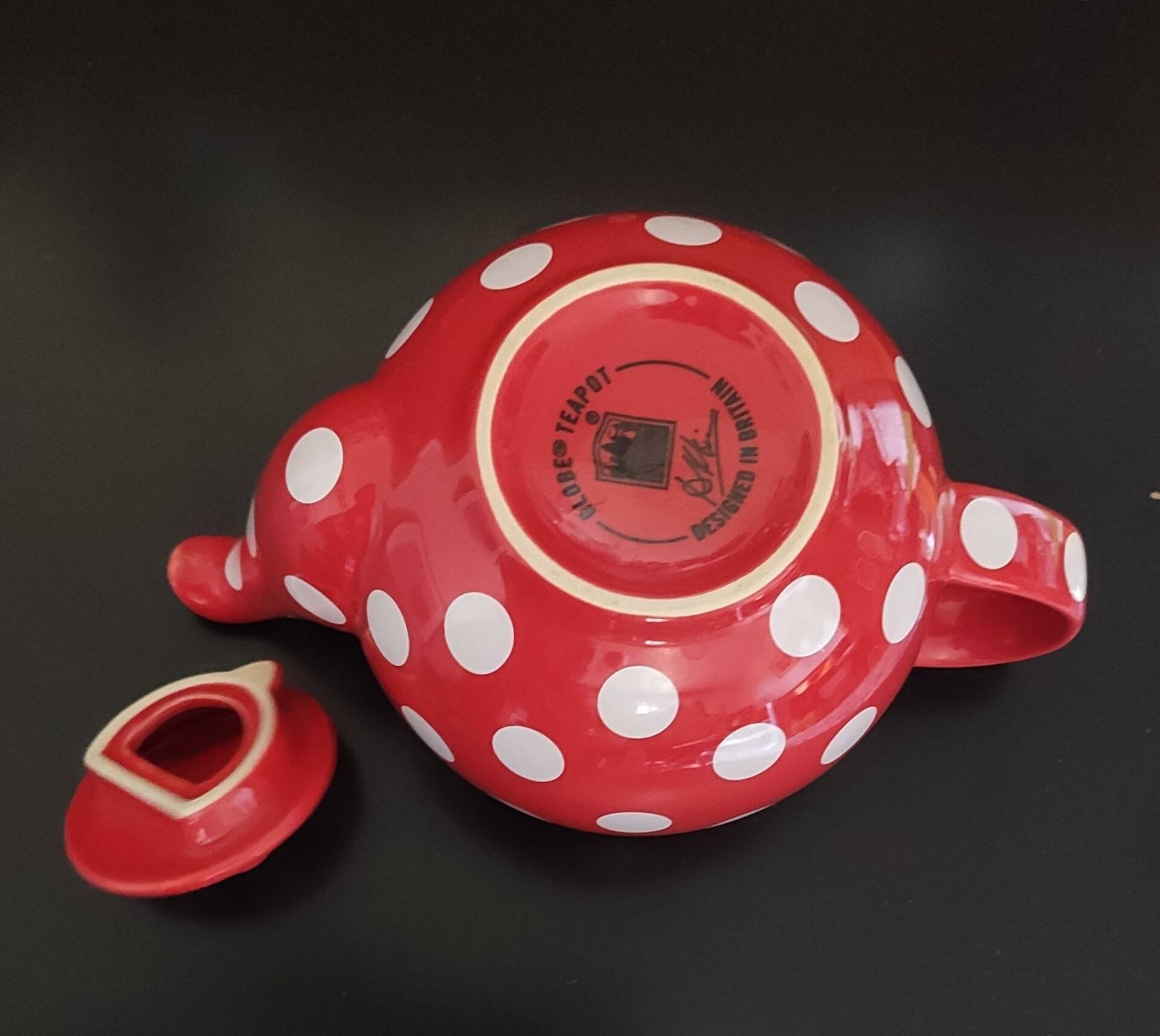 Pretty round English teapot with red polka dots.