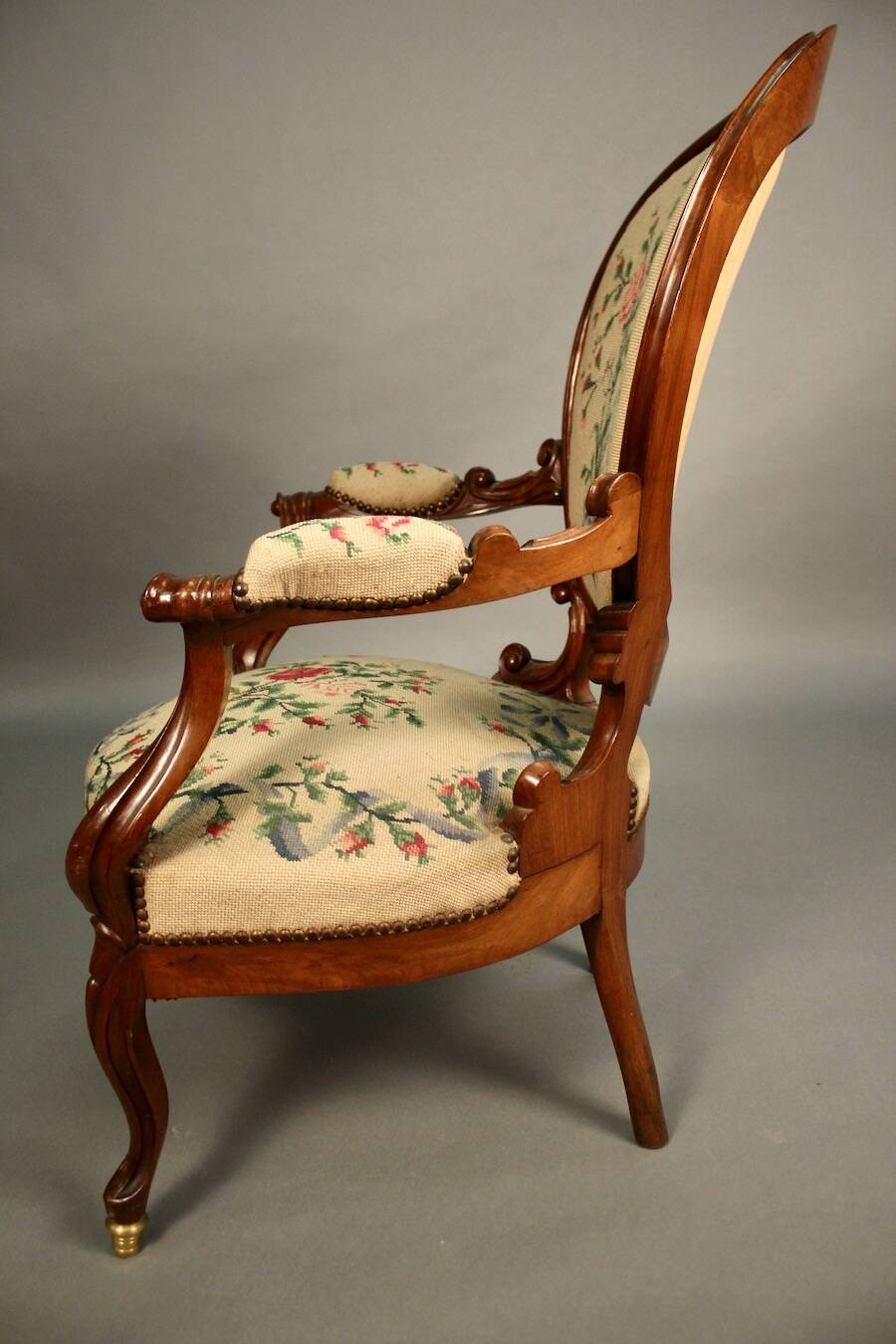 Pair of Louis Philippe armchairs with petit point upholstery.