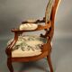 Pair of Louis Philippe armchairs with petit point upholstery.
